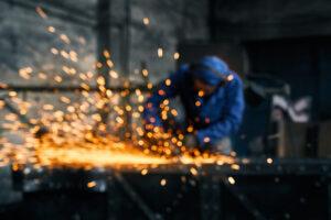 Engineer cutting metals with thermal lancing machine